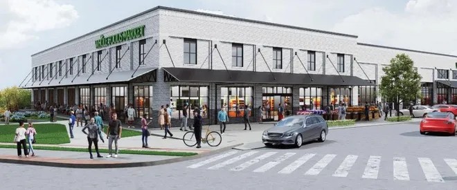 Rendering of a white brick building with a Whole Foods Market sign, tall storefront windows and black awnings at a street corner with a crosswalk