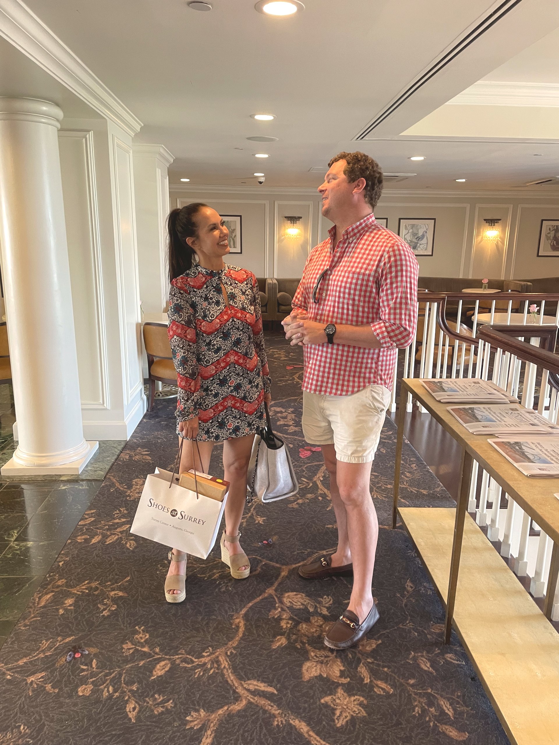 Two guests talking in the lobby of Charleston Place in June 2022