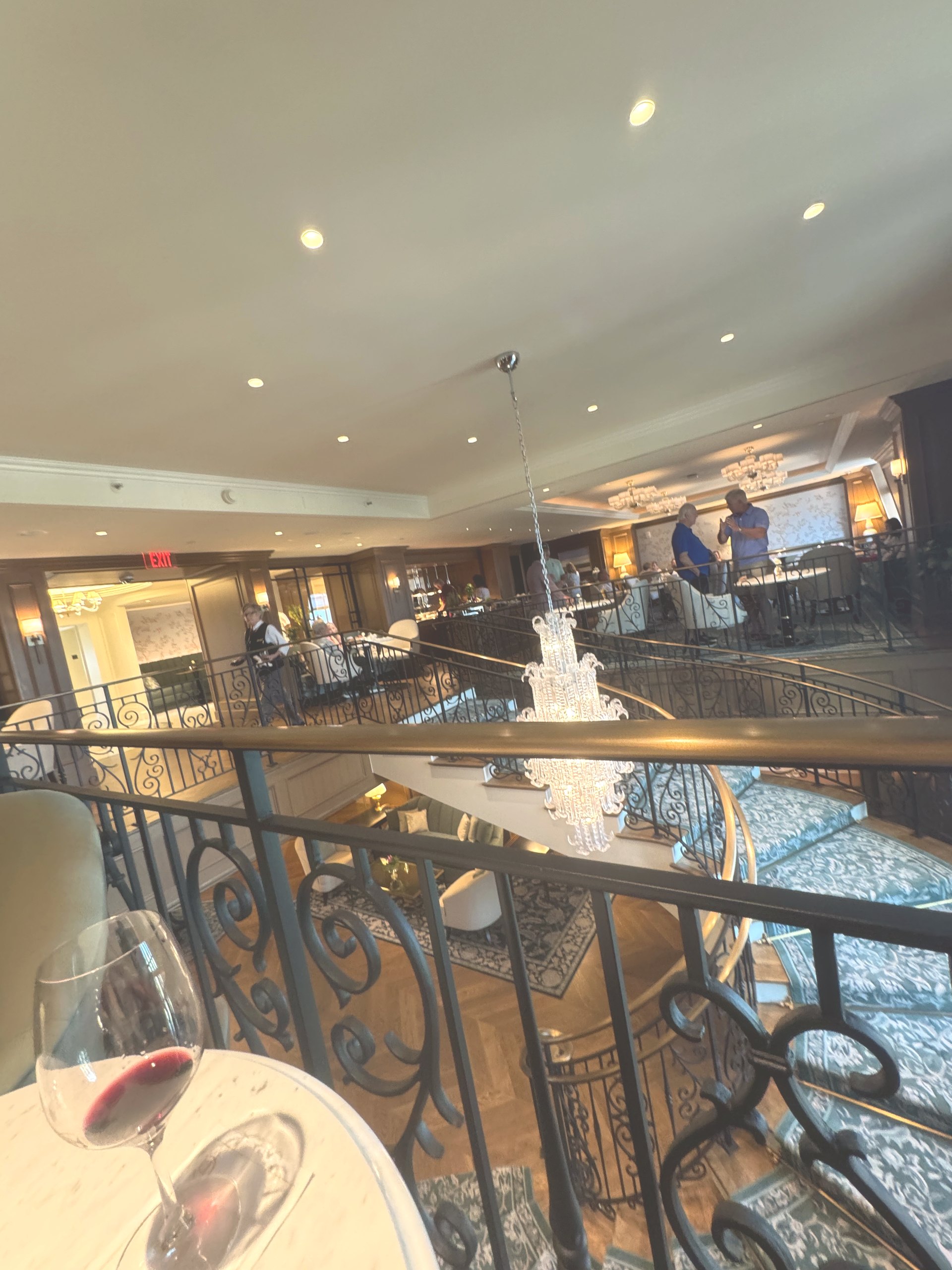 The two story Club Lounge at The Charleston Place with seating overlooking the lower floor