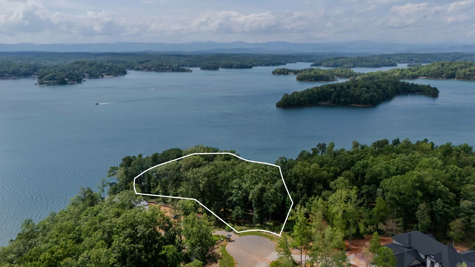 Aerial photograph of 233 Sandy Hollow Court with the parcel outlined on its point in Lake Keowee