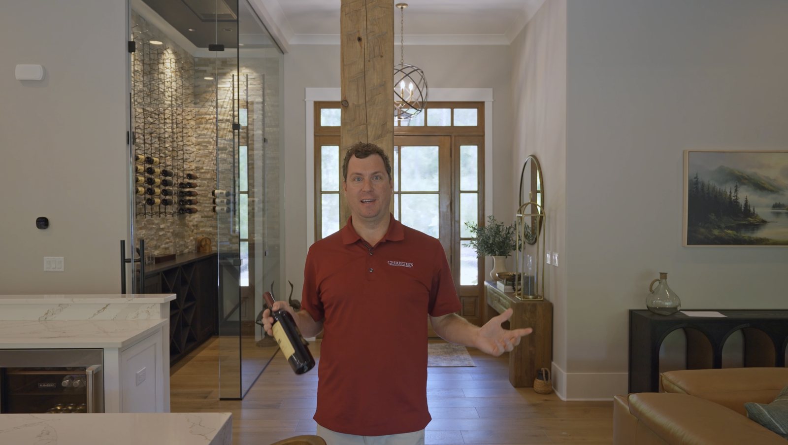 Damian Hall in the great room beside the glass-walled, climate-controlled wine room