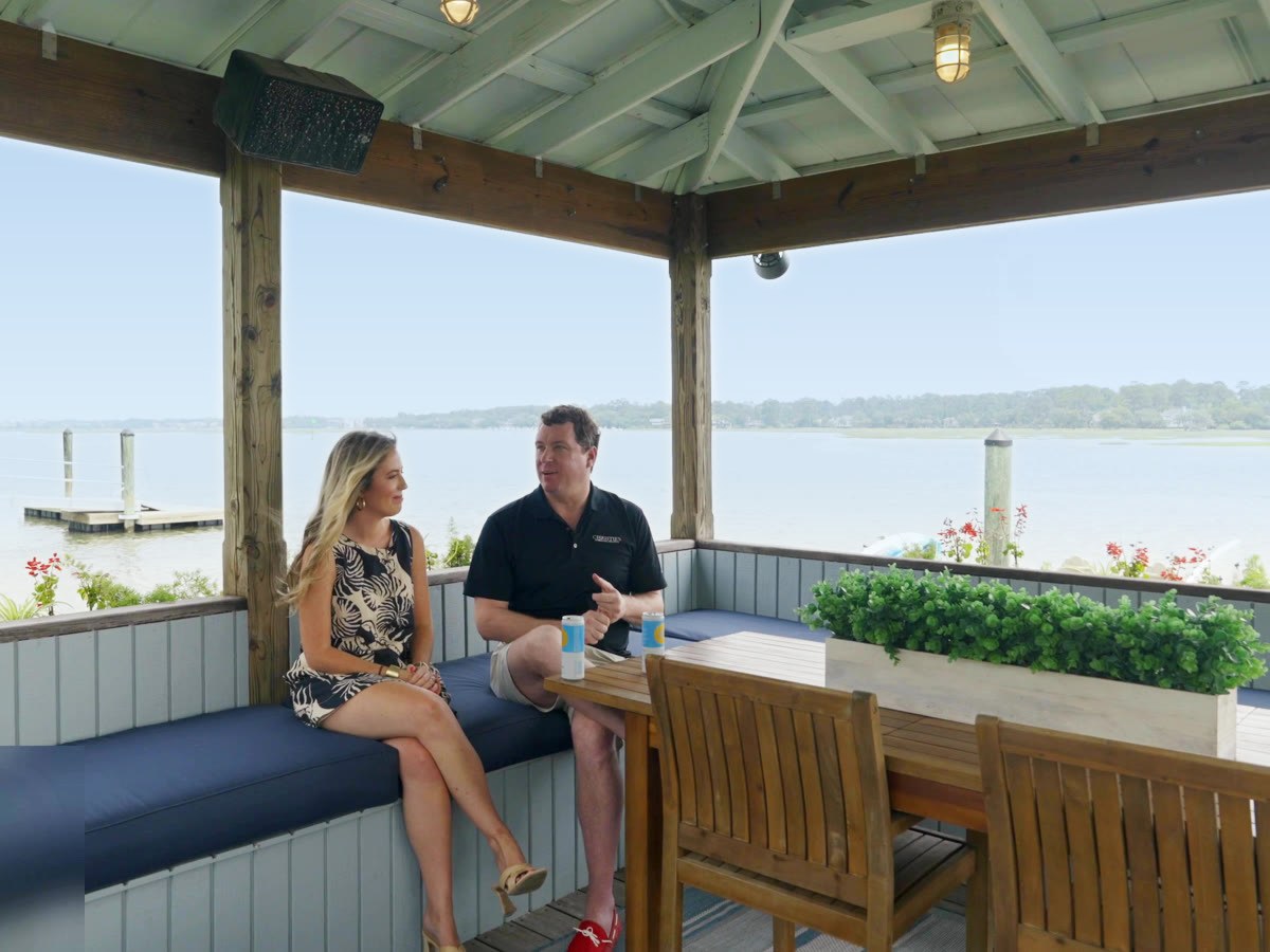 Damian Hall and Lindy Maxey-Kopotic talking on the covered dock at Tidewater Manor, Hilton Head Island