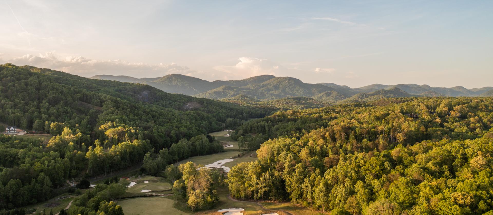 Aerial view over the course at The Cliffs at Mountain Park toward the Blue Ridge