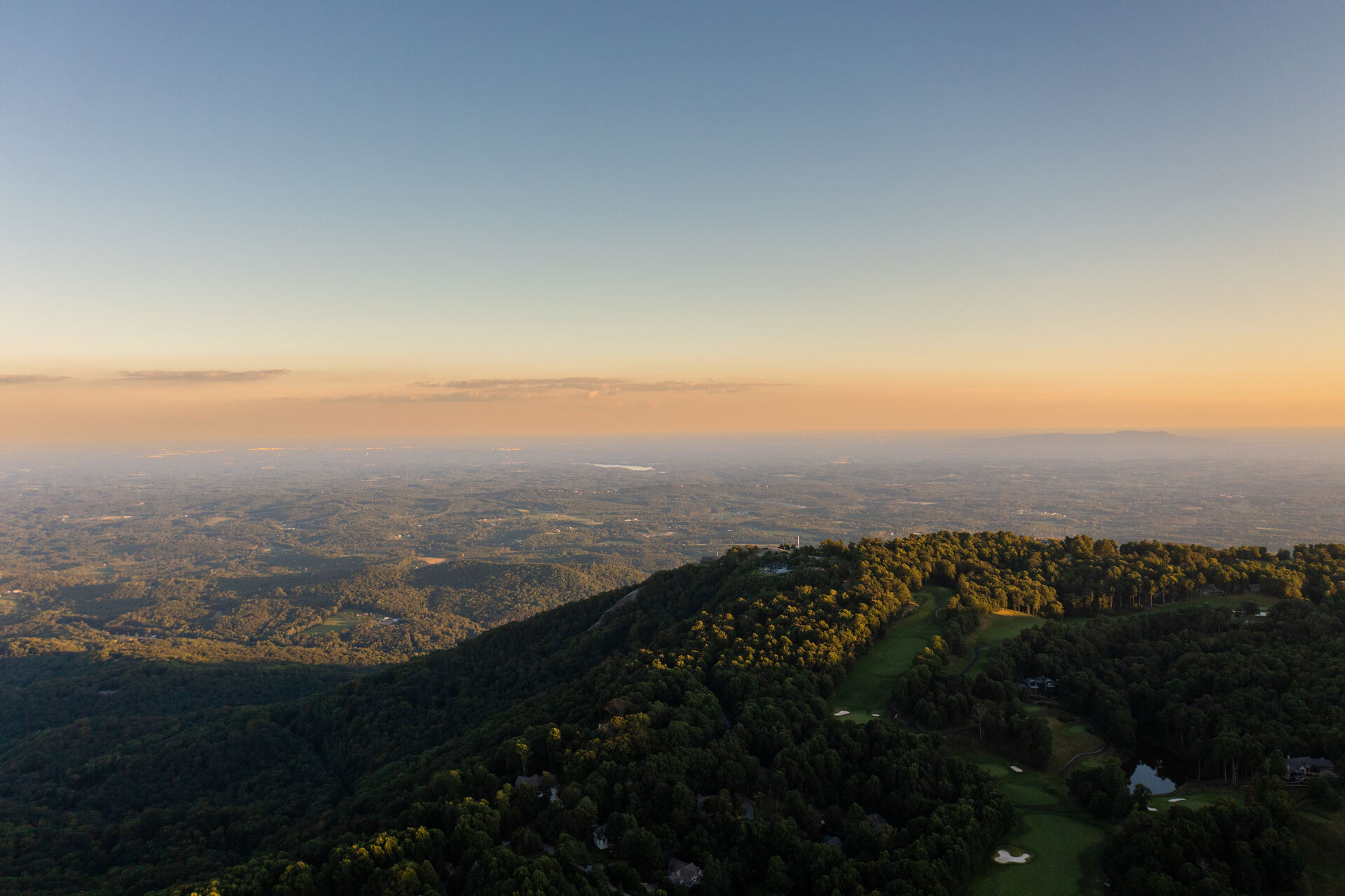 A Blue Ridge escarpment at sunrise, the piedmont opening out below