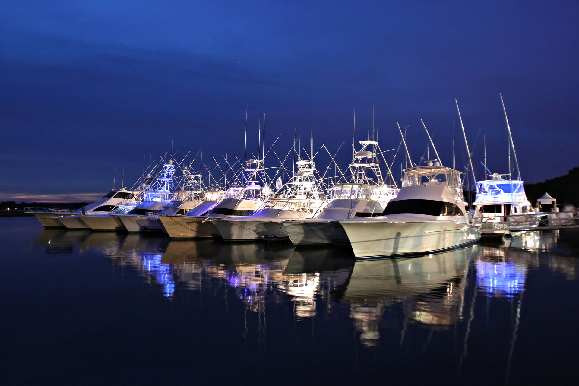 A Lowcountry marina at blue hour, masts and reflections along the docks