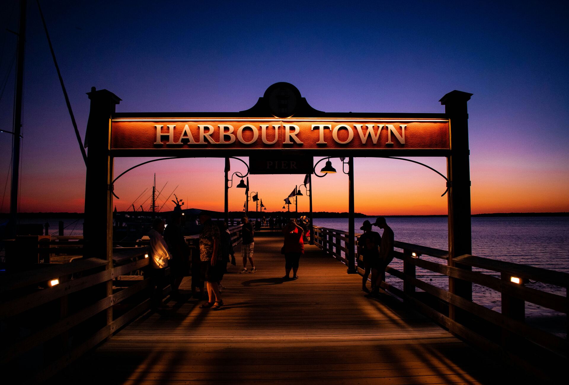 The Harbour Town sign over the boardwalk at sunset