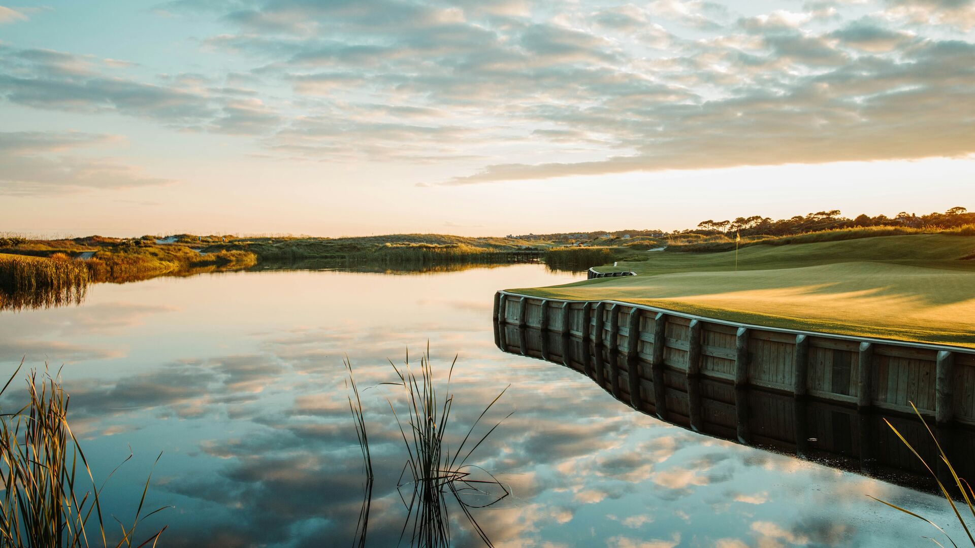 A tidal creek and a low dock going quiet at dusk on the Kiawah marsh