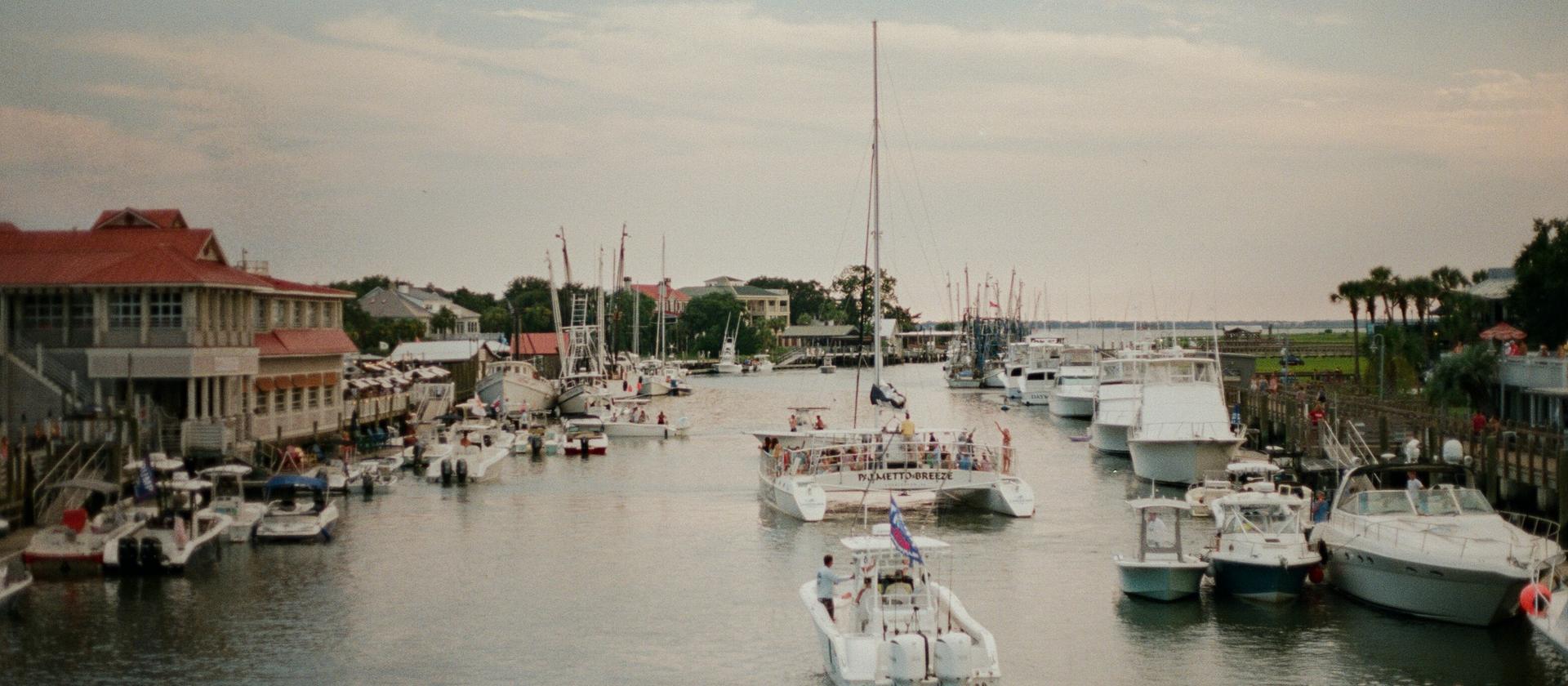 Charter boats and restaurant decks on Shem Creek in Mount Pleasant at dusk